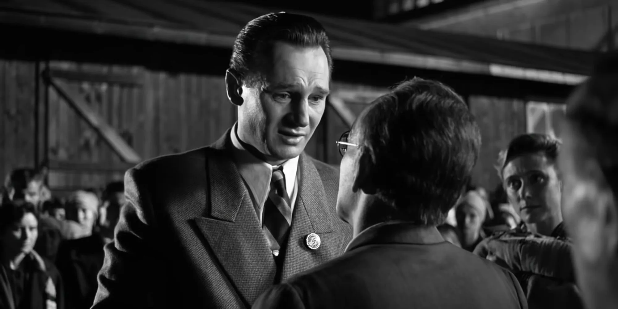 Liam Neeson as Oskar Schindler crying while facing a man in Schindler’s List